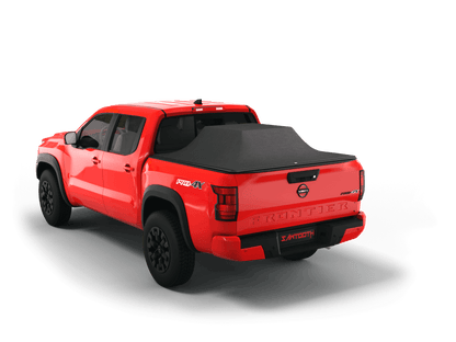 Red Nissan Frontier with loaded and expanded Sawtooth Stretch pickup truck bed cover