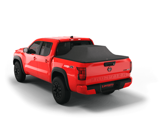 Red Nissan Frontier with loaded and expanded Sawtooth Stretch pickup truck bed cover