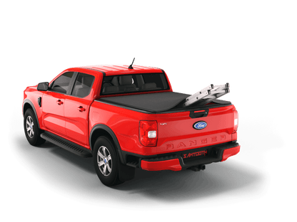 Red Ford Ranger with ladder sticking out of Sawtooth Stretch expandable truck bed cover