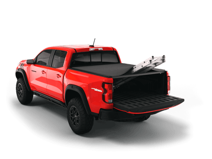 Red Chevrolet Colorado / GMC Canyon with Sawtooth Stretch expandable tonneau cover rolled up at cab