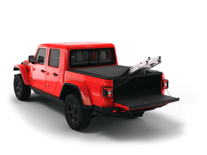 Red Jeep Gladiator with Sawtooth Stretch expandable tonneau cover rolled up at cab