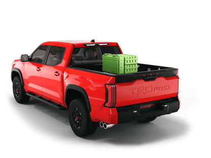 Red Toyota Tundra with gear in the truck bed and the Sawtooth Stretch tonneau cover rolled up at cab 