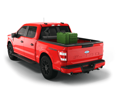 Red Ford F-150 with gear in the truck bed and the Sawtooth Stretch tonneau cover rolled up at cab 