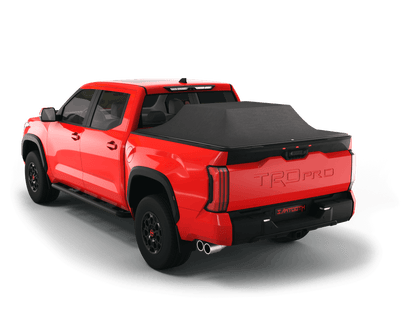 Red Toyota Tundra with gear in the truck bed and the Sawtooth Stretch tonneau cover expanded over cargo load