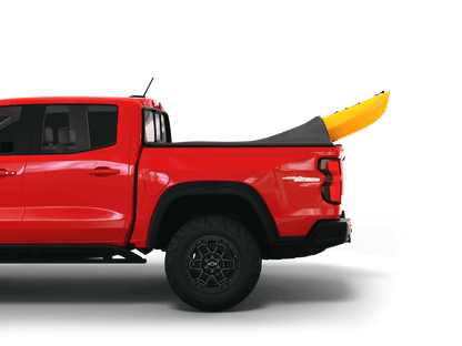 Red Chevrolet Colorado / GMC Canyon with yellow kayak under sawtooth stretch truck bed cover