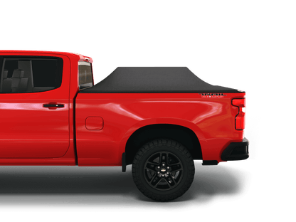 Red Chevrolet Silverado 1500 / GMC Sierra 1500 with Sawtooth Stretch tonneau cover expanded over cargo load