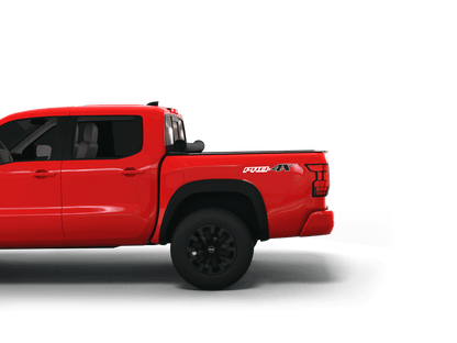 Red Nissan Frontier with Sawtooth Stretch expandable pickup truck bed cover rolled up at cab