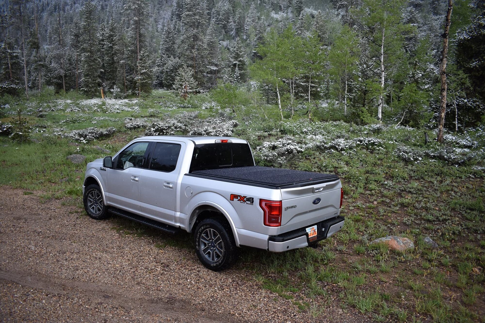 Silver F-150 with flat expandable Sawtooth Stretch tonneau in the mountains